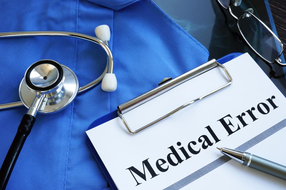 Medical error report with stethoscope and doctor robe.