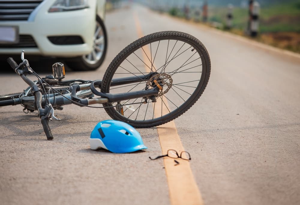 Accident car crash with bicycle on road