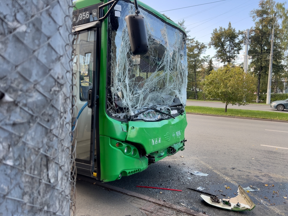 City bus with completely shattered windshield and debris after a serious collision