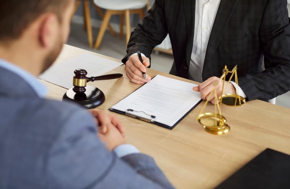 A lawyer discussing the wrongful death case documents with client