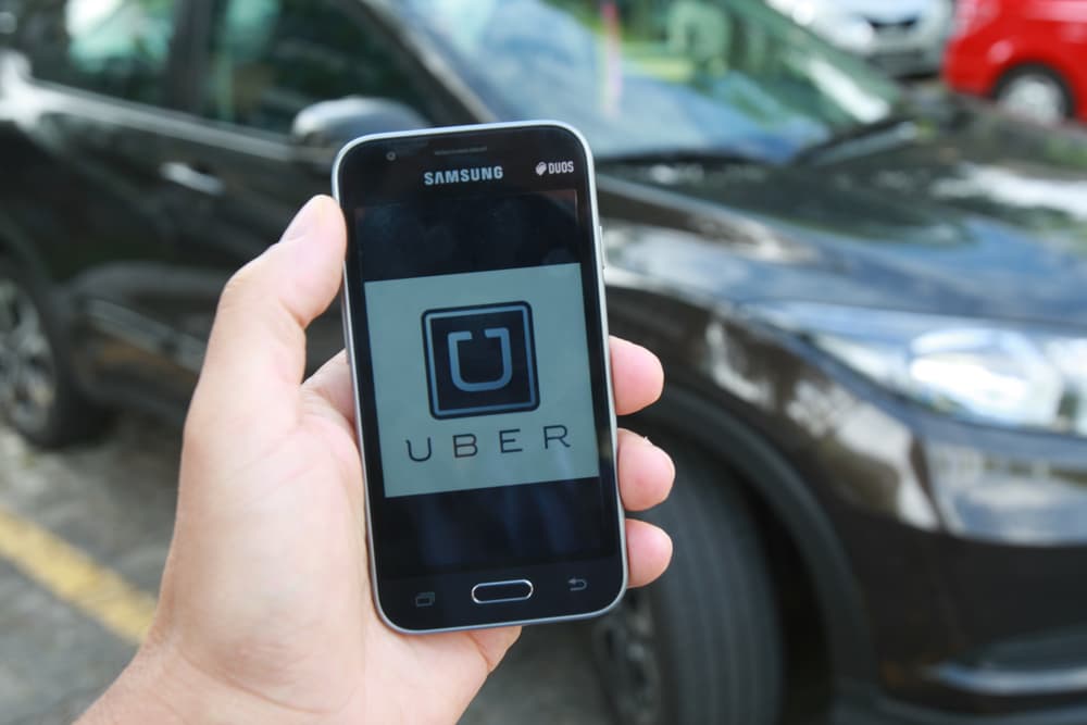 A man is booking a ride through Uber App