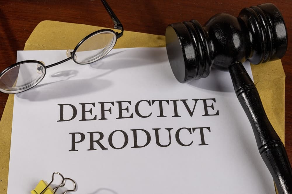 Defective Product Title on Legal Documents Set on Desk &ndash; Legal Concept