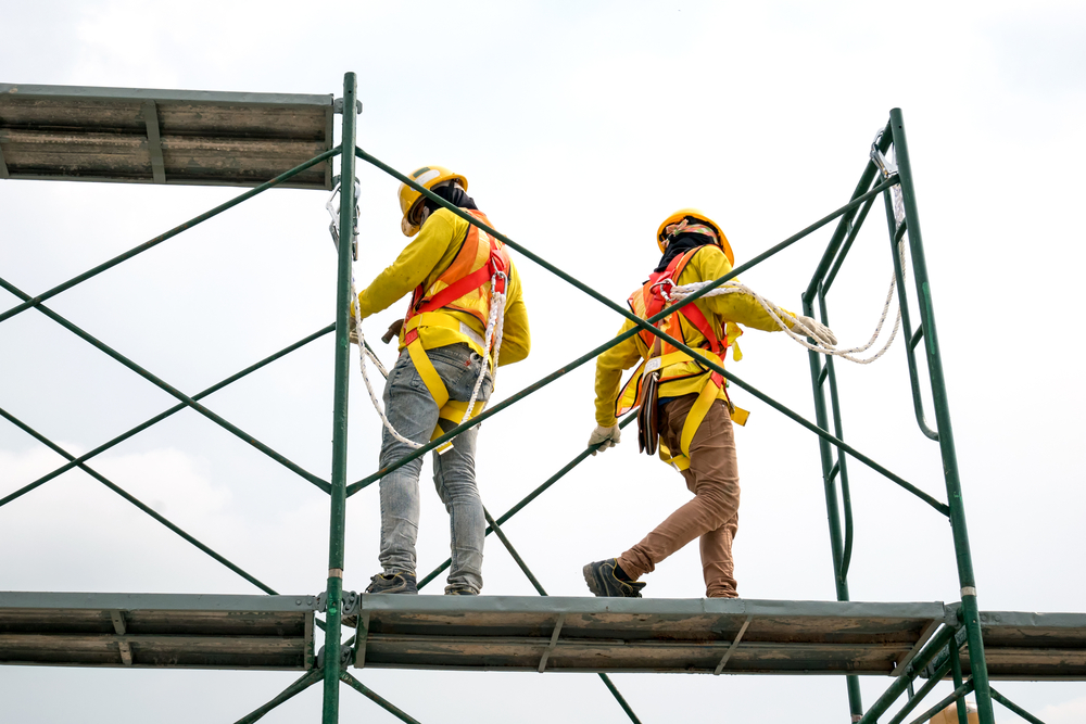 Workers tethered to scaffolding