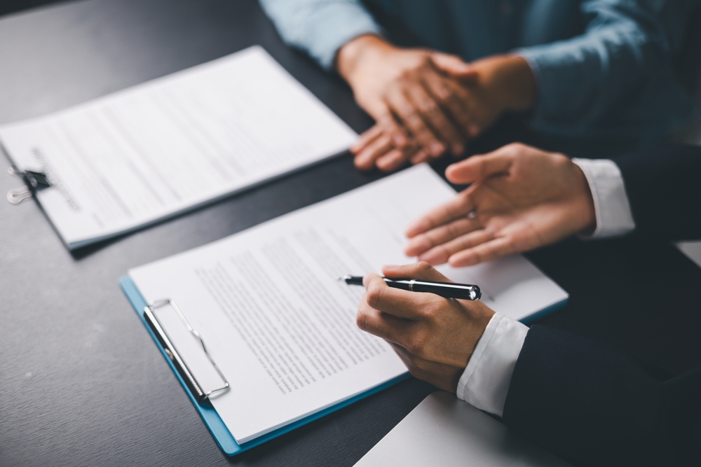 Lawyer and client discuss contract over a table