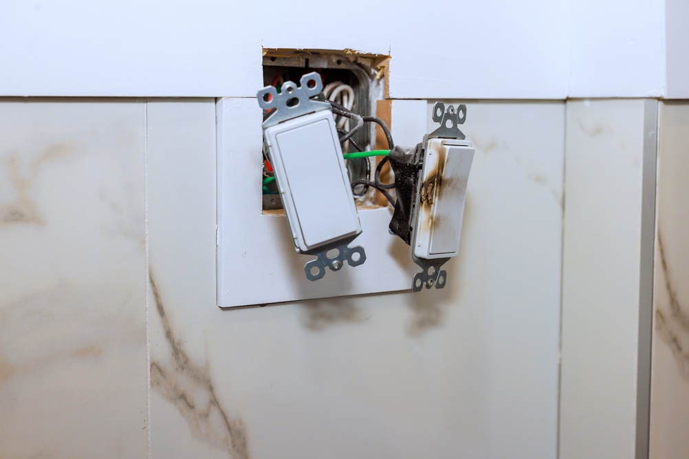 Damaged light switch posing an electrocution risk