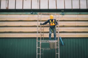 Construction worker using a ladder
