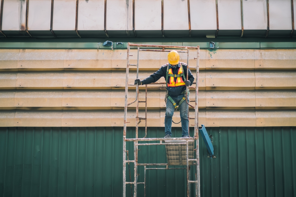 Construction worker using a ladder