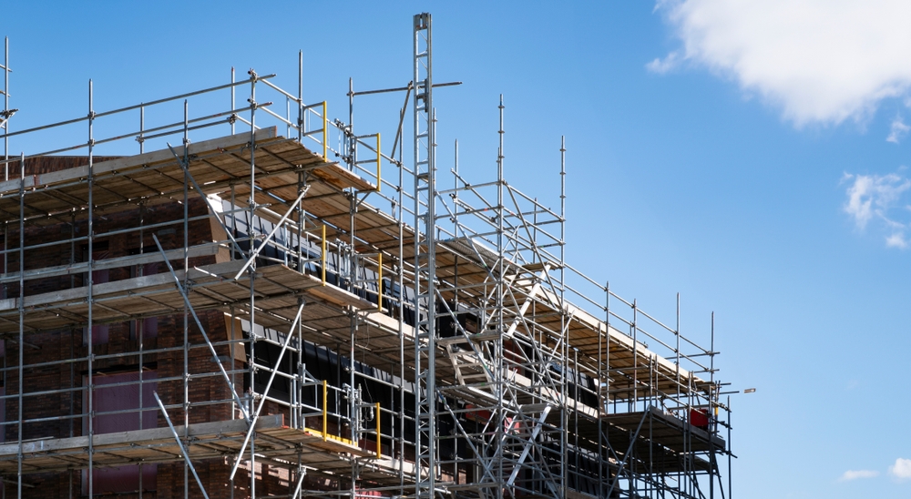 Elaborate scaffolding setup against a building that is under construction