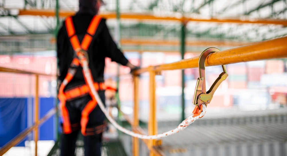 worker on scaffolding attached with safety tether
