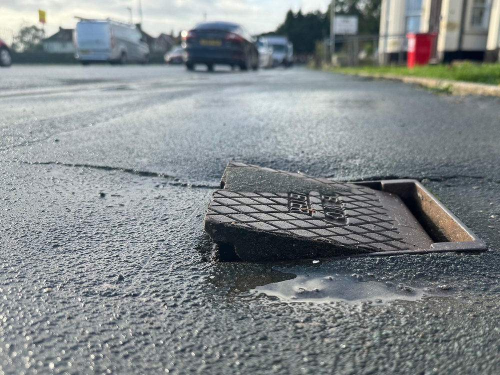 A cap to a utility access creates a tripping hazard on the sidewalk