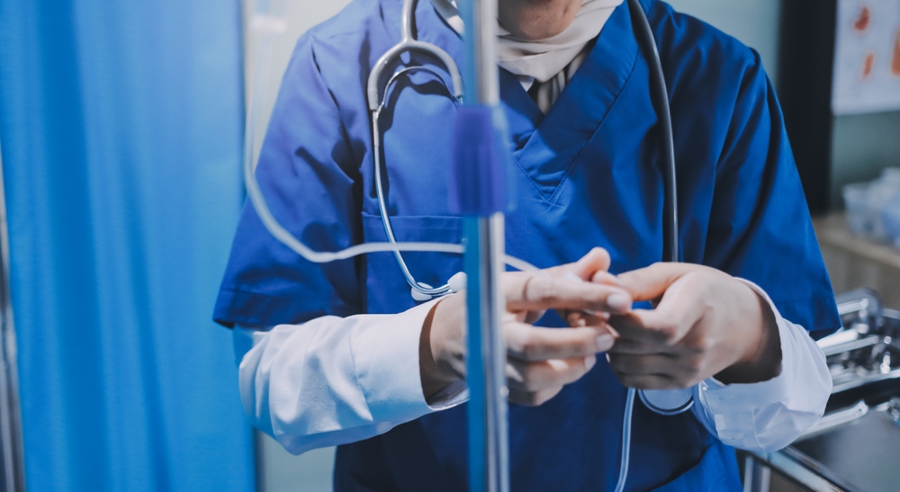 Close-up of nurse administering medication through IV